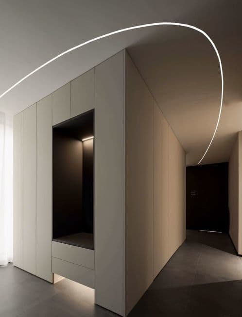 Metal-framed drywall partition with a door opening inside a bright room