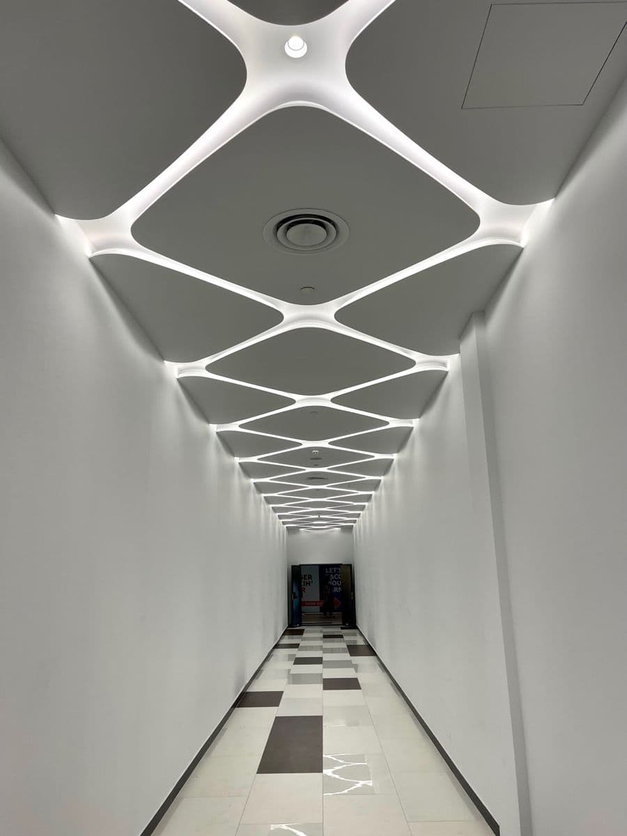 Panelled ceiling with a framed track-lighting layout above a restaurant dining area
